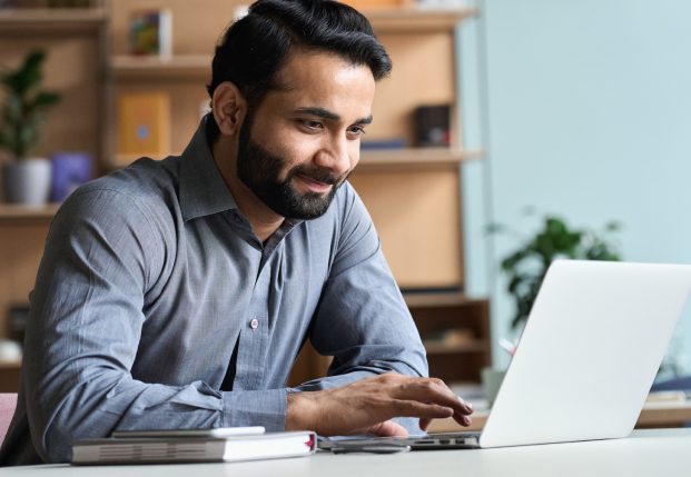 Business man in office using his laptop