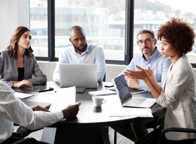 Group of business people in conference room collaborating.