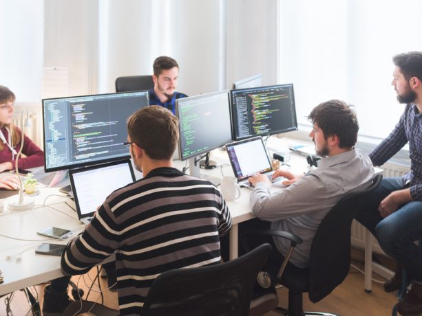 Group of developers working together in an office and collaborating